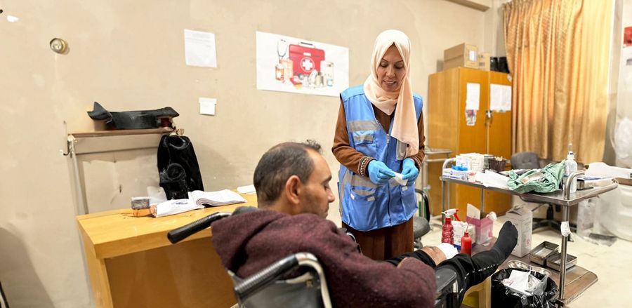 A Muslim Hands worker supporting a beneficiary