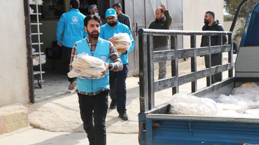 Volunteers carrying food parcels